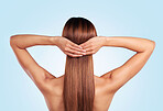 Back, hair care and beauty of woman in studio isolated on a blue background. Hairstyle, keratin cosmetics and aesthetics of young female model with salon treatment for growth, texture and balayage.