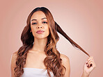 Face portrait, hair care and beauty of woman in studio isolated on a pink background. Aesthetics, cosmetics and female model with salon treatment for balayage, growth and texture for curly hairstyle.
