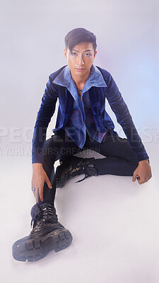 Buy stock photo Makeup, portrait of gay man on floor in fashion and pride in Indonesia isolated on purple background. Confidence, aesthetic and lgbt model with beauty in studio, non binary and gender neutral design.