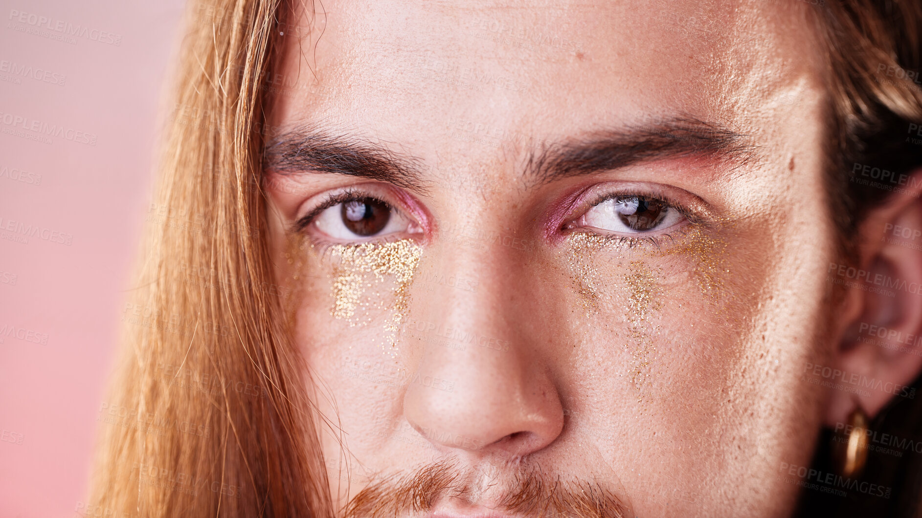 Buy stock photo Makeup, eyes and portrait of gen z man with serious expression on face with pink background. Gold, glitter tears and art, zoom on eye cosmetics on non binary, transgender or gender neutral lgbt model