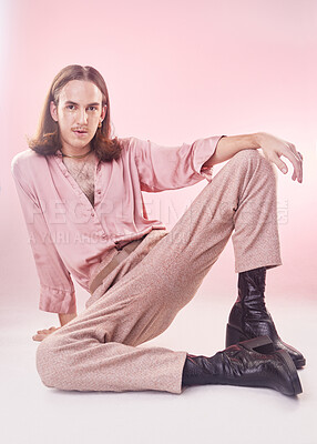 Buy stock photo Fashion, pose and portrait of lgbt man with pride and confidence isolated on pink background. Style, creative retro aesthetic and gay model, beauty and non binary or gender neutral design in studio.