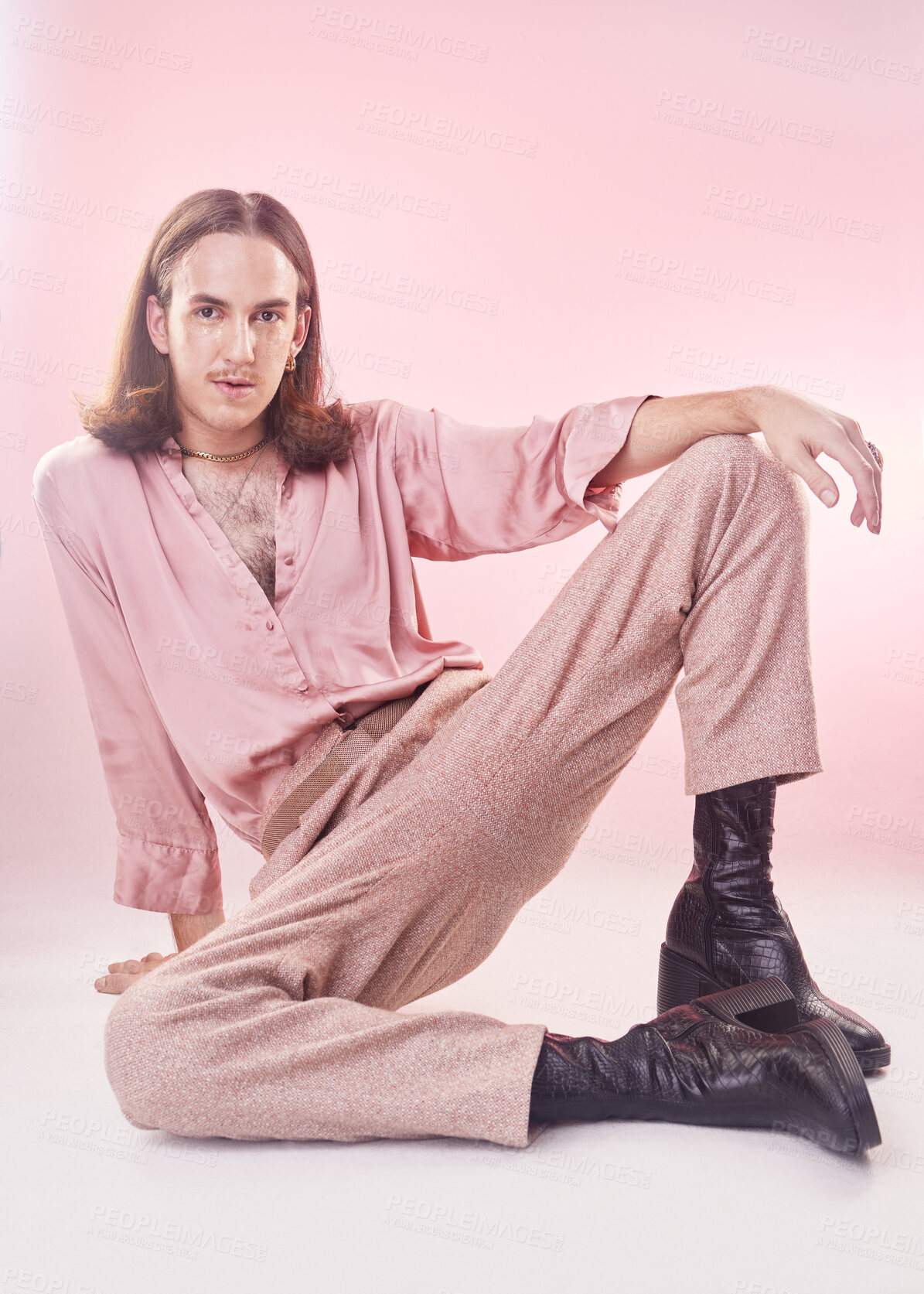 Buy stock photo Fashion, pose and portrait of lgbt man with pride and confidence isolated on pink background. Style, creative retro aesthetic and gay model, beauty and non binary or gender neutral design in studio.