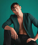 Gen z, fashion model portrait and non binary person with designer clothing with green background. Isolated, studio and modern hipster clothes of an lgbtq and serious adult with youth and cool style