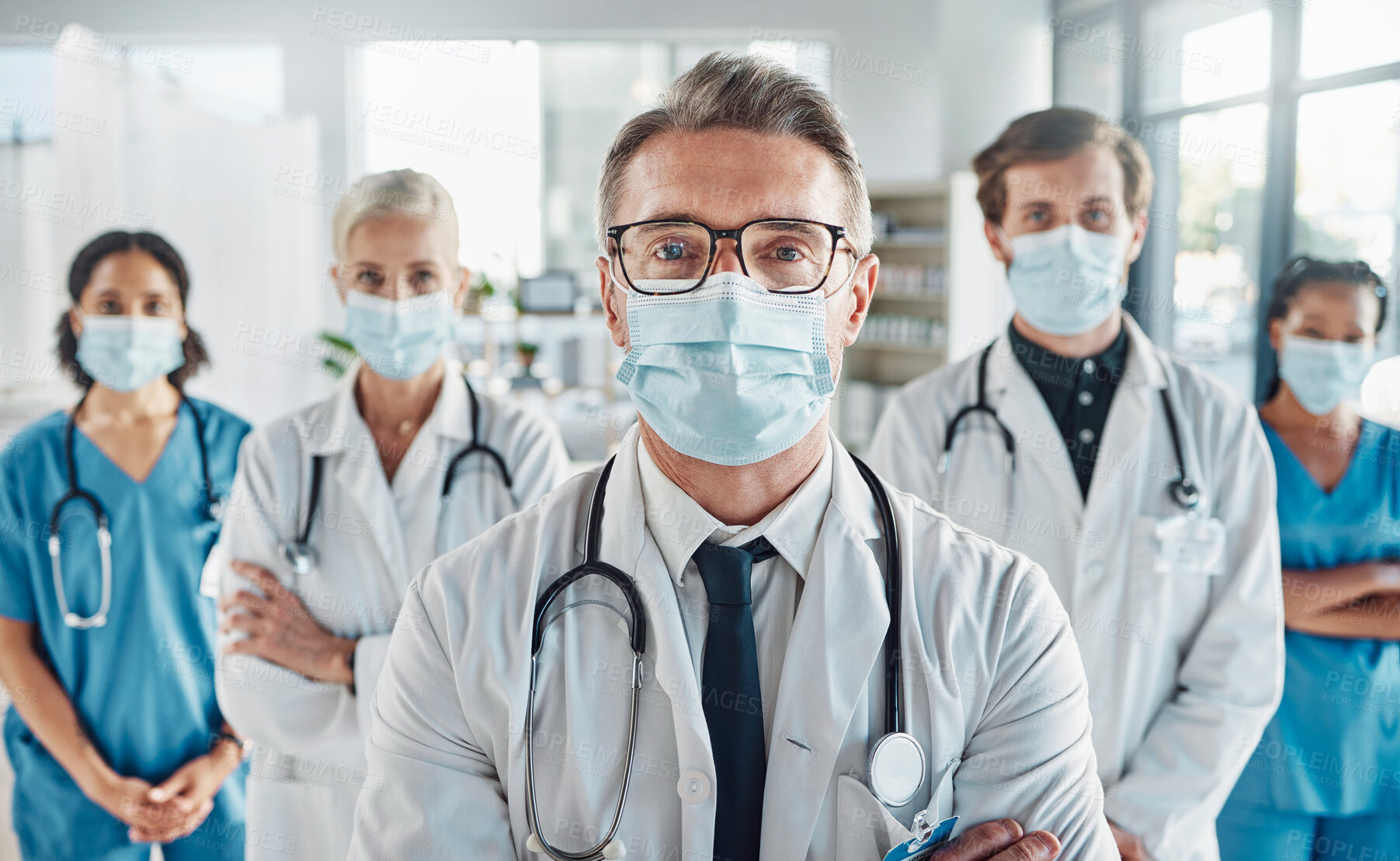 Buy stock photo Covid, teamwork and team portrait of doctors and nurses in hospital, support and success in healthcare. Health, help and medicine, confident senior doctor and happy medical employees smile together.