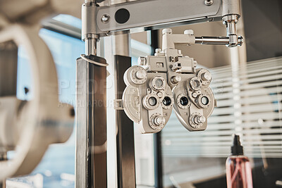 Buy stock photo Vision, optometry and healthcare in an optician office with an ophthalmic phoropter machine for testing. Hospital, medical and eye health with test equipment in an empty room at the optometrist