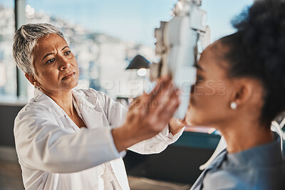 Buy stock photo Senior optometrist woman, eye exam patient and medical goal in hospital, consulting room and office with help. Elderly optician, eyesight test and phoropter for wellness, health and vision analysis