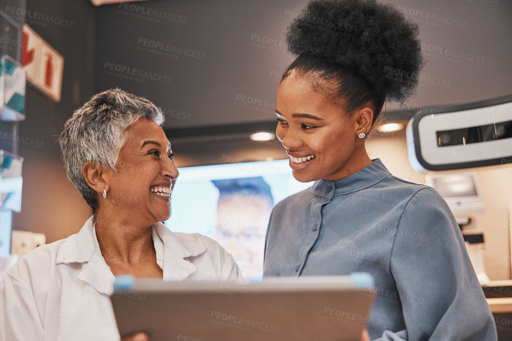 Buy stock photo Optometry, tablet and optometrist talking to a patient about eye test results or consultation. Discussion, technology and senior optician speaking to a female with a mobile device at a optical clinic