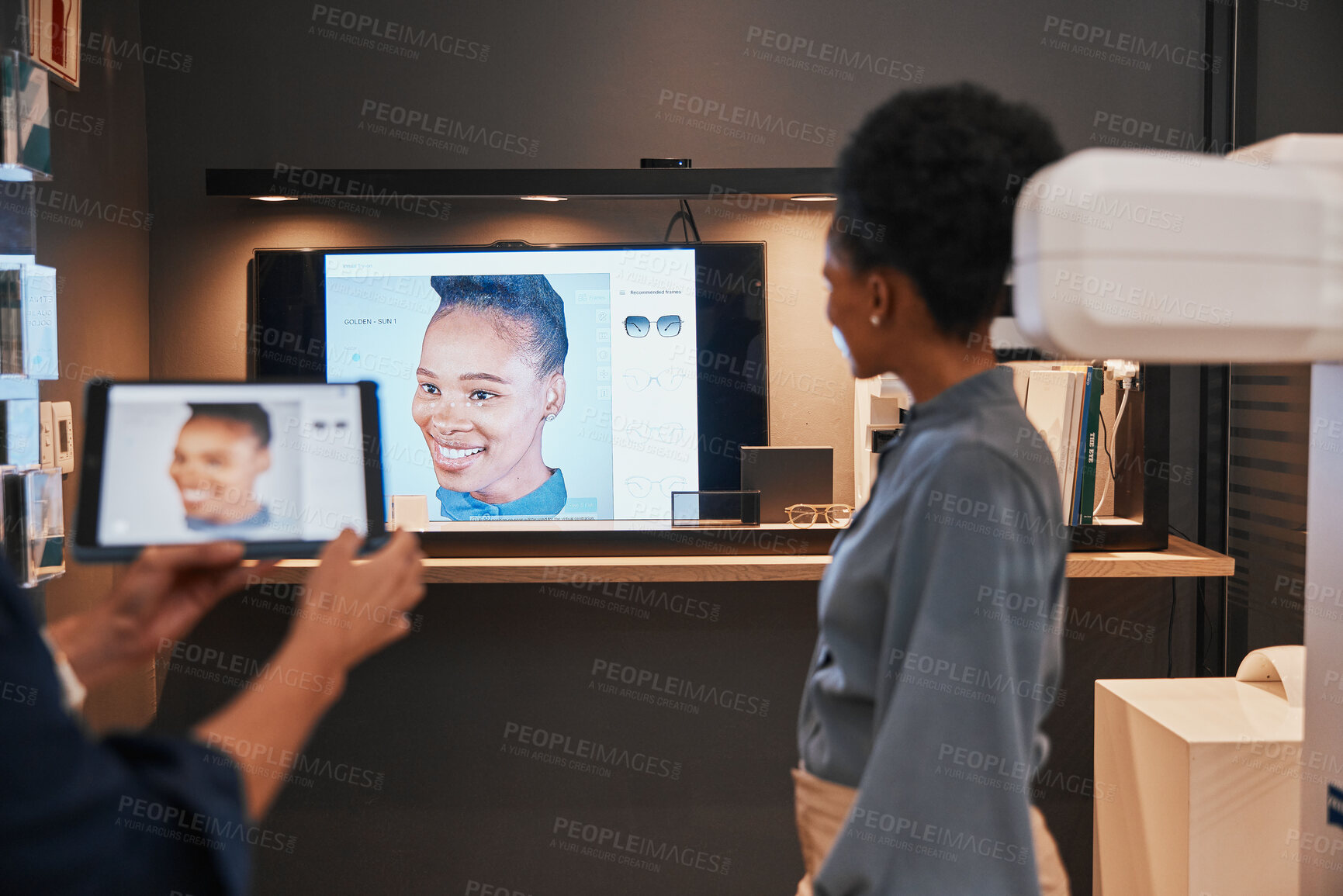 Buy stock photo Optometry, glasses and black woman with television for choice of frames or spectacles at night in shop. Vision, ophthalmologist and optician with tablet to choose or shopping for prescription lenses.