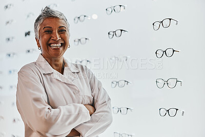 Buy stock photo Portrait, woman and smile of optician with arms crossed in shop or store for glasses, eyewear or spectacles. Ophthalmology, vision and laughing, proud and confident senior female medical optometrist.