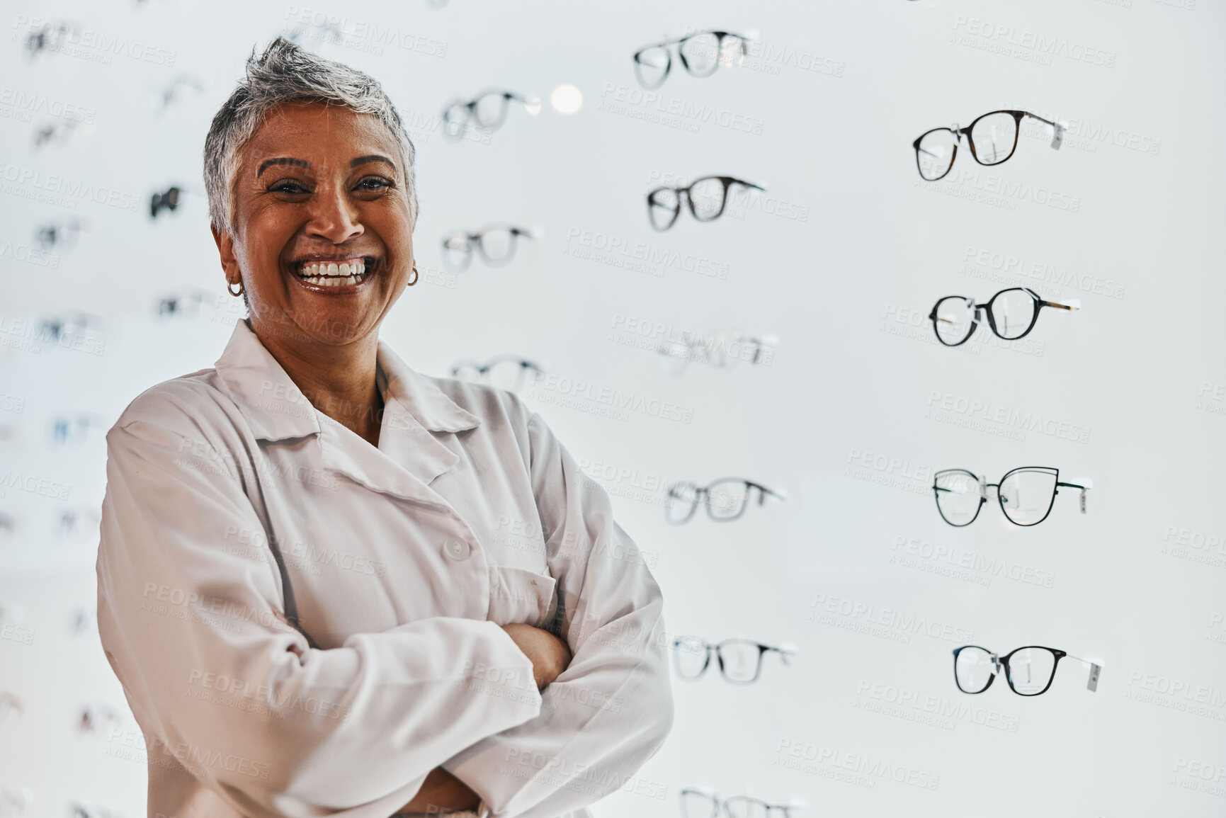 Buy stock photo Portrait, woman and smile of optician with arms crossed in shop or store for glasses, eyewear or spectacles. Ophthalmology, vision and laughing, proud and confident senior female medical optometrist.