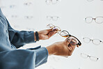 Glasses choice, black woman hands and customer with store worker at optician looking at lense. Eye consulting, smile and eyewear shopping in a frame shop for vision and prescription exam for eyes