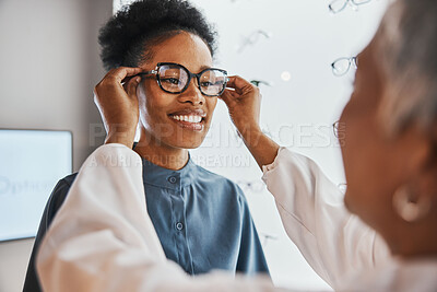 Buy stock photo Glasses check, black woman and customer with store worker and optician looking at lense. Eye consulting, smile and eyewear assessment in a frame shop for vision test and prescription exam for eyes