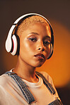 Portrait, music headphones and black woman in studio isolated on a background. Face makeup, beauty technology and female model streaming or listening to radio, audio album or podcast with headset.