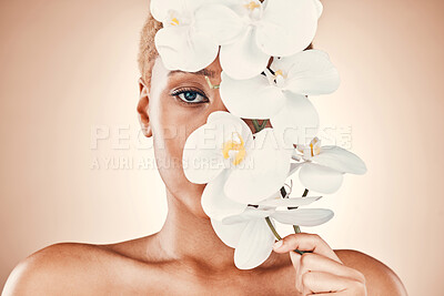 Buy stock photo Orchid flower, skincare and black woman portrait with spa aesthetic for luxury and wellness. Beauty, studio and cosmetics of a young model with flowers for organic facial and dermatology treatment