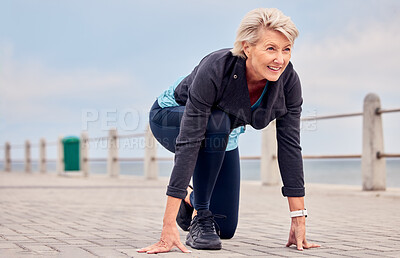 Buy stock photo Senior woman, starting position and running outdoor at beach promenade, exercise or sky mockup. Elderly lady ready to run for fitness, cardio training and smile for sports marathon, health or mindset