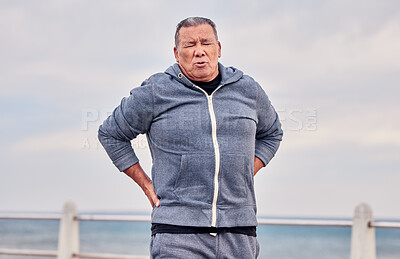 Buy stock photo Back pain, fitness and senior man outdoor at beach with scoliosis, sports wound and risk. Male runner, spine injury and joint problem of body muscle, first aid and health emergency at ocean promenade