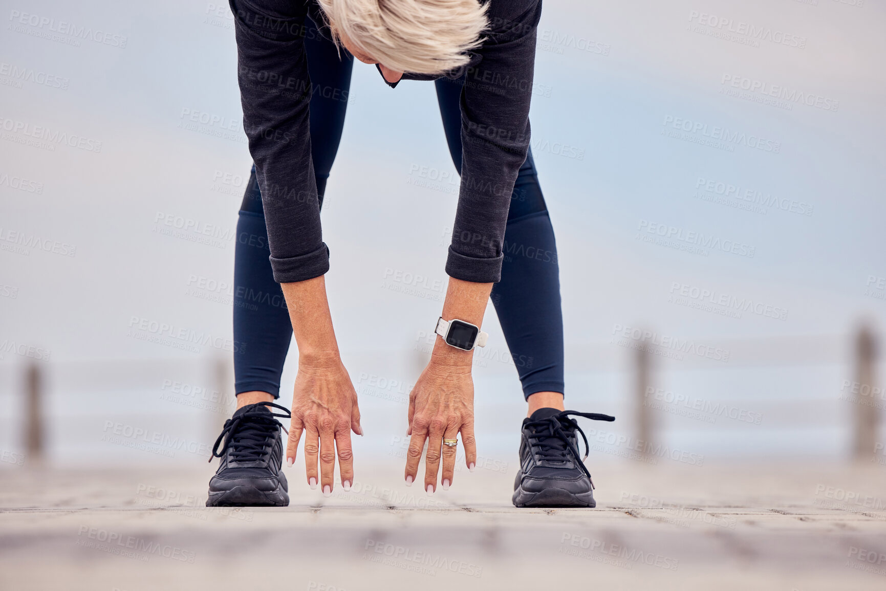 Buy stock photo Woman stretching hands, legs and reaching ground for exercise, training and healthy wellness outdoors. Sports lady bending for warm up, body workout and fitness at beach promenade 