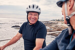 Bike, cycling and beach with a old couple riding outdoor on the promenade during summer for exercise. Bicycle, fitness or leisure with a senior man and woman taking a ride together on their bikes