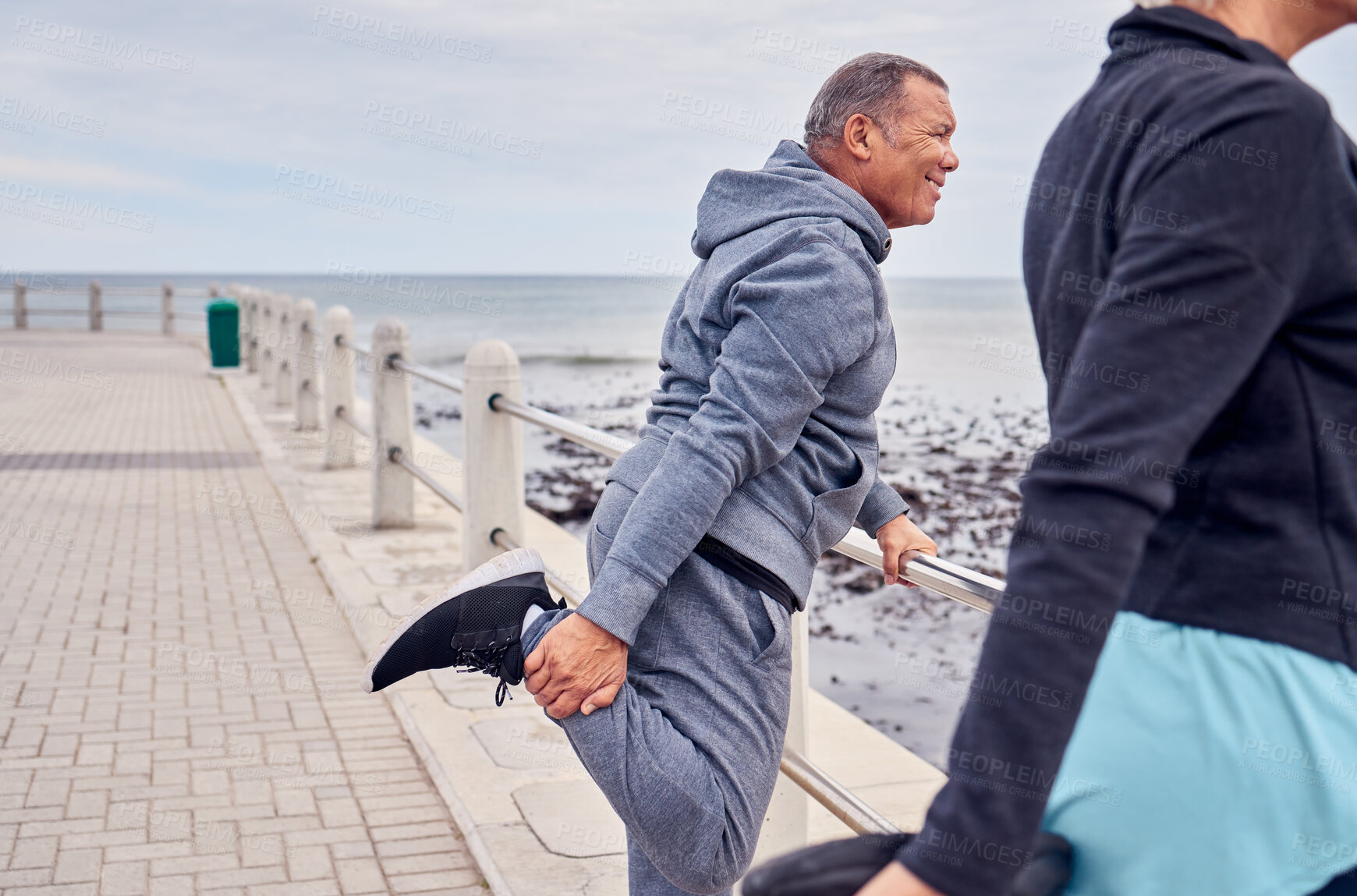 Buy stock photo Stretching legs, exercise and senior couple by ocean for fitness, healthy body and wellness in retirement. Sports, pilates and elderly man and woman ready for warm up, cardio workout and training