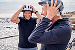 Helmet, funny and a senior couple cycling outdoor together for fitness or an active lifestyle. Summer, exercise or humor with a mature man and woman laughing at a joke on the promenade during summer