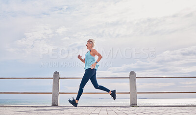 Buy stock photo Senior woman running outdoor at on sky mockup at beach promenade for energy, health and cardio workout. Elderly female, exercise and runner at ocean for sports training, fitness and healthy marathon