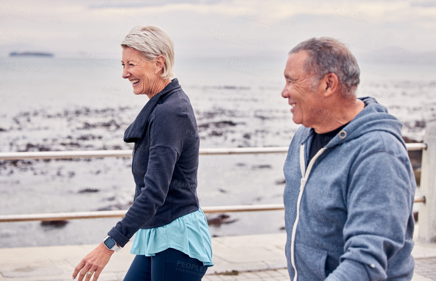 Buy stock photo Walking, fitness and senior couple smile by ocean for exercise, healthy body and wellness in retirement. Sports, relax and happy elderly man and woman ready for warm up, cardio workout and training