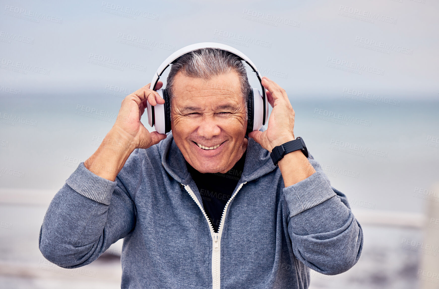 Buy stock photo Portrait, music and fitness with a senior man outdoor on the promenade for a cardio or endurance workout. Headphones, running and training with a mature male outside by the beach for exercise