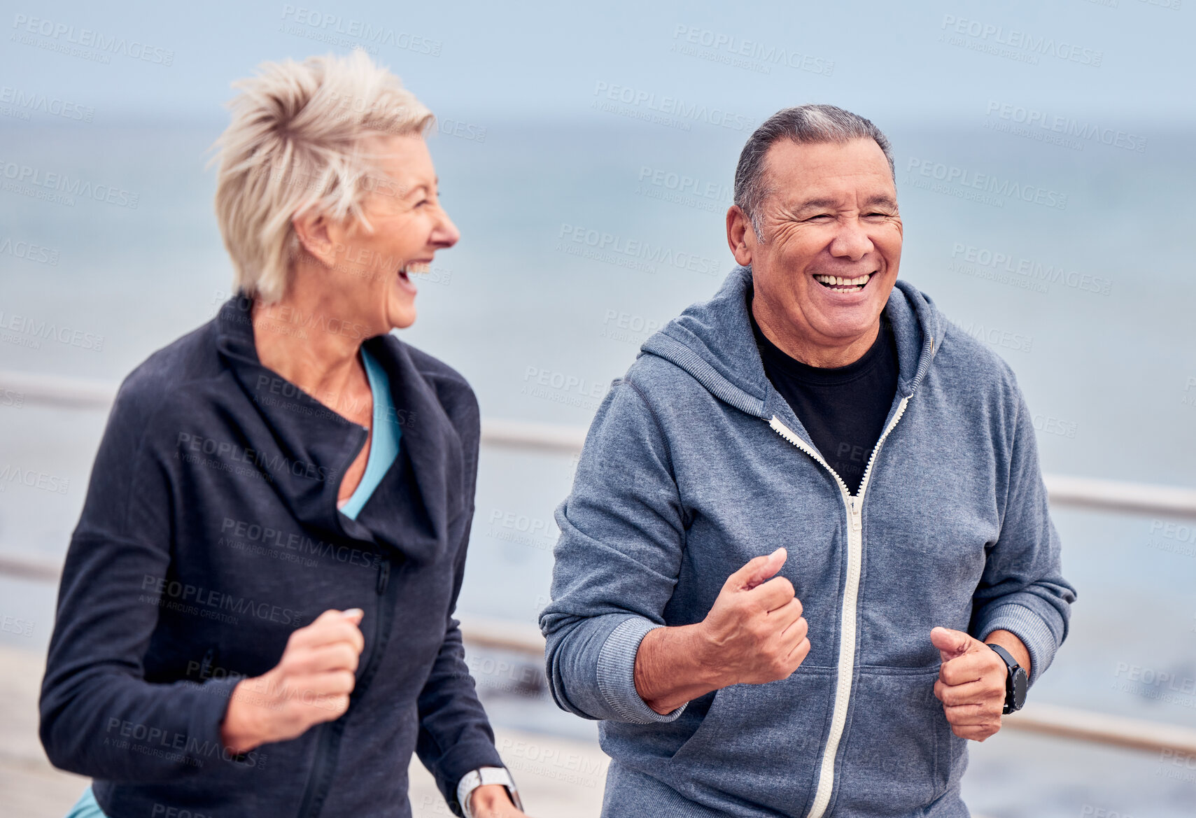 Buy stock photo Running, fitness and senior couple smile by ocean for exercise, healthy body and wellness in retirement. Sports, endurance and happy elderly man and woman run, cardio workout and marathon training