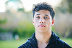 Man, portrait and face at outdoor park in summer for walk, wellness and fitness by blurred background. Young gen z guy, headshot and nature in spring with handsome, confident and focus in sunshine