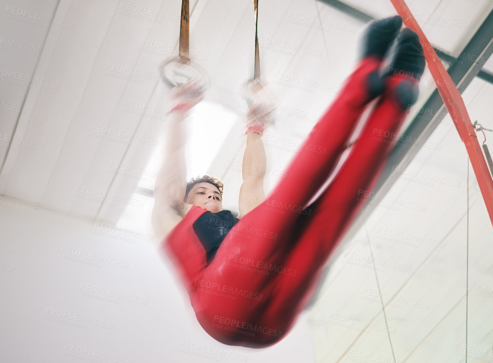 Buy stock photo Gymnastics, ring and sports with man in stadium and speed for fitness, workout or health challenge. Wellness, exercise and training with athlete lifting in gym arena for strong, power and motion blur