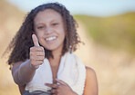 Thumbs up, fitness and a sports woman on a blurred background outdoor for a cardio or endurance workout. Hand sign, exercise and running with a femae athlete standing outside for health or wellness