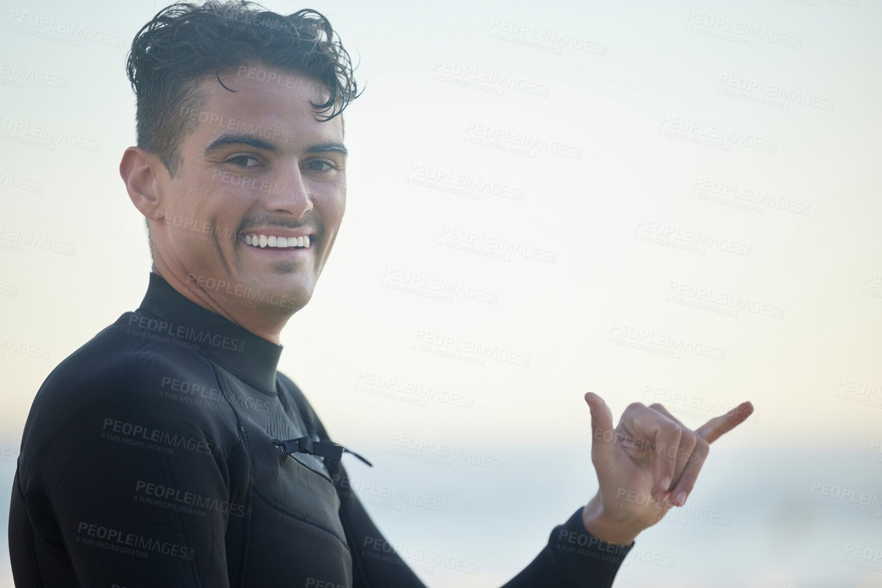 Buy stock photo Shaka, portrait and man surfer at the beach for water sports training or exercise while on vacation. Happy, smile and male athlete with a hang loose hand sign ready for a surfing workout in Australia