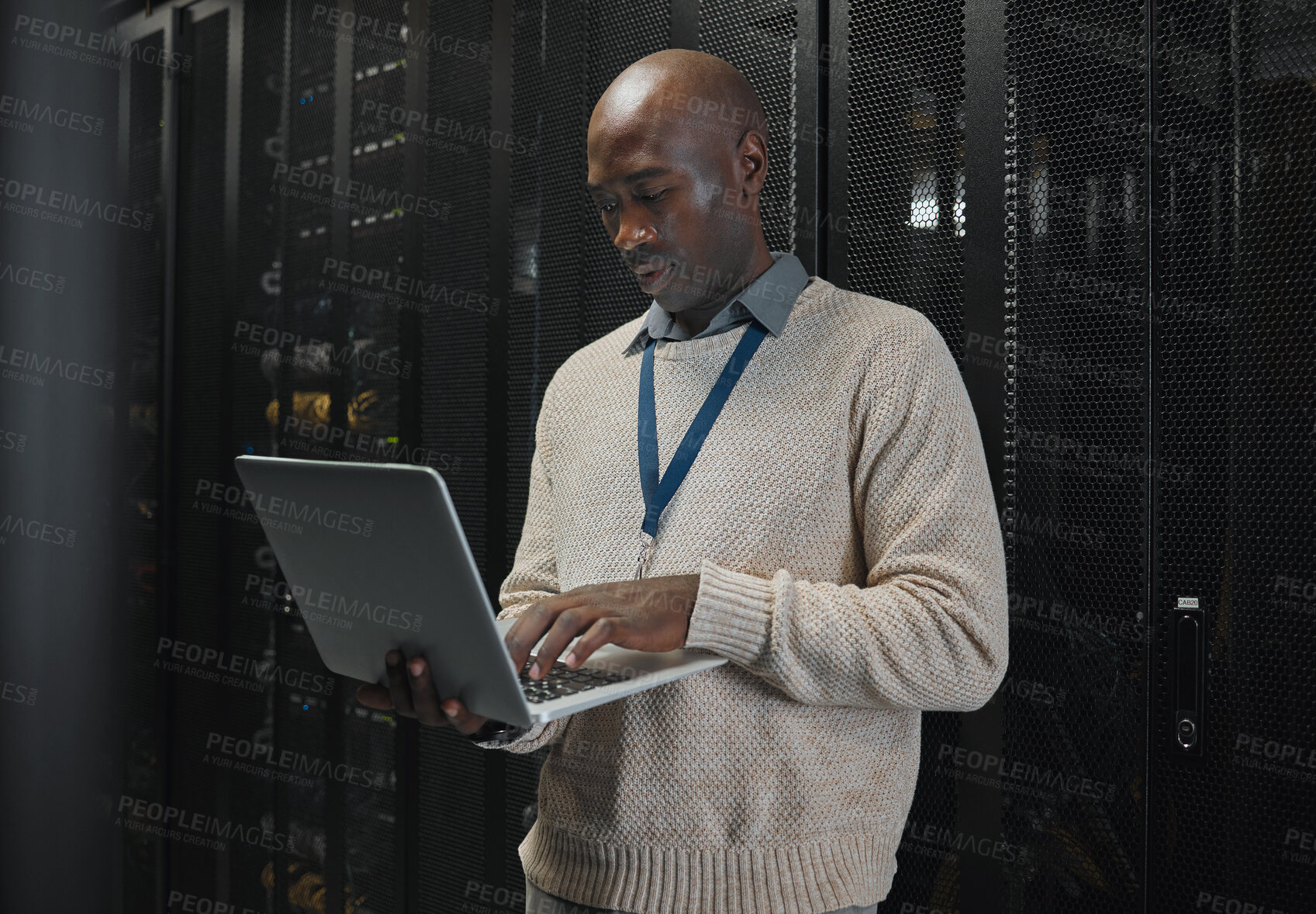 Buy stock photo Server room, laptop and black man technician with data center management, system and cybersecurity. Focus, serious and inspection of engineering or programmer person with information technology code