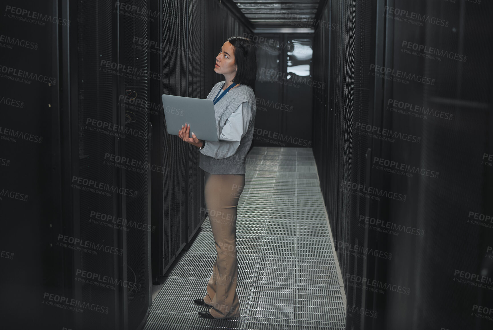 Buy stock photo Woman with laptop, server room and information technology, technician and datacenter with software update. Tech industry, cybersecurity and network with Asian female setting up firewall and database