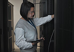 Tablet, server room and engineering with a programmer asian woman at work on a computer mainframe. Software, database and information technology with a female coder working alone on a cyber network