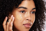 Black woman, beauty and face, foundation and makeup, cosmetics product zoom and cream on studio background. Hand, skin and wellness with dermatology, cosmetic care and sunscreen with African female