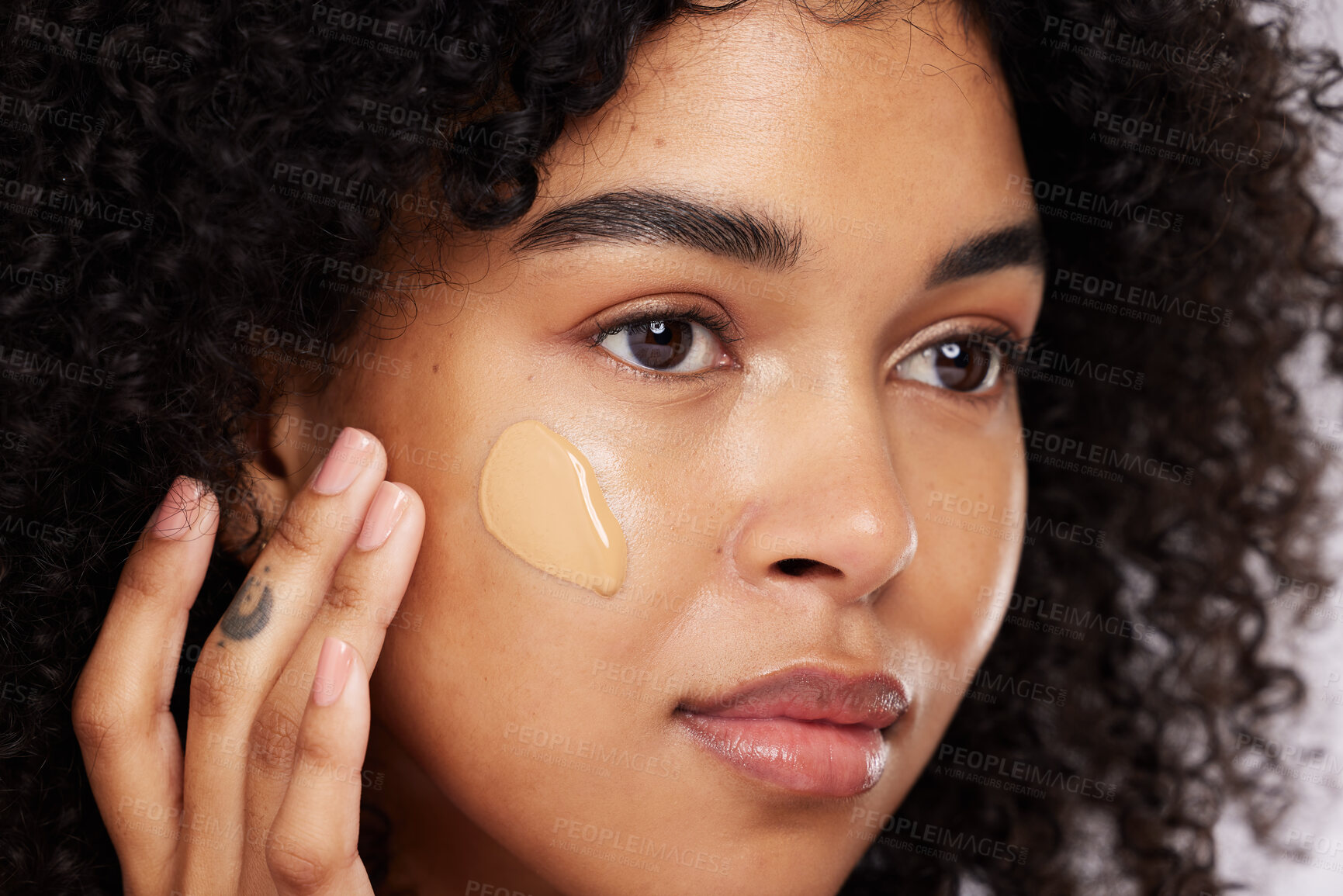 Buy stock photo Black woman, beauty and face, foundation and makeup, cosmetics product zoom and cream on studio background. Hand, skin and wellness with dermatology, cosmetic care and sunscreen with African female