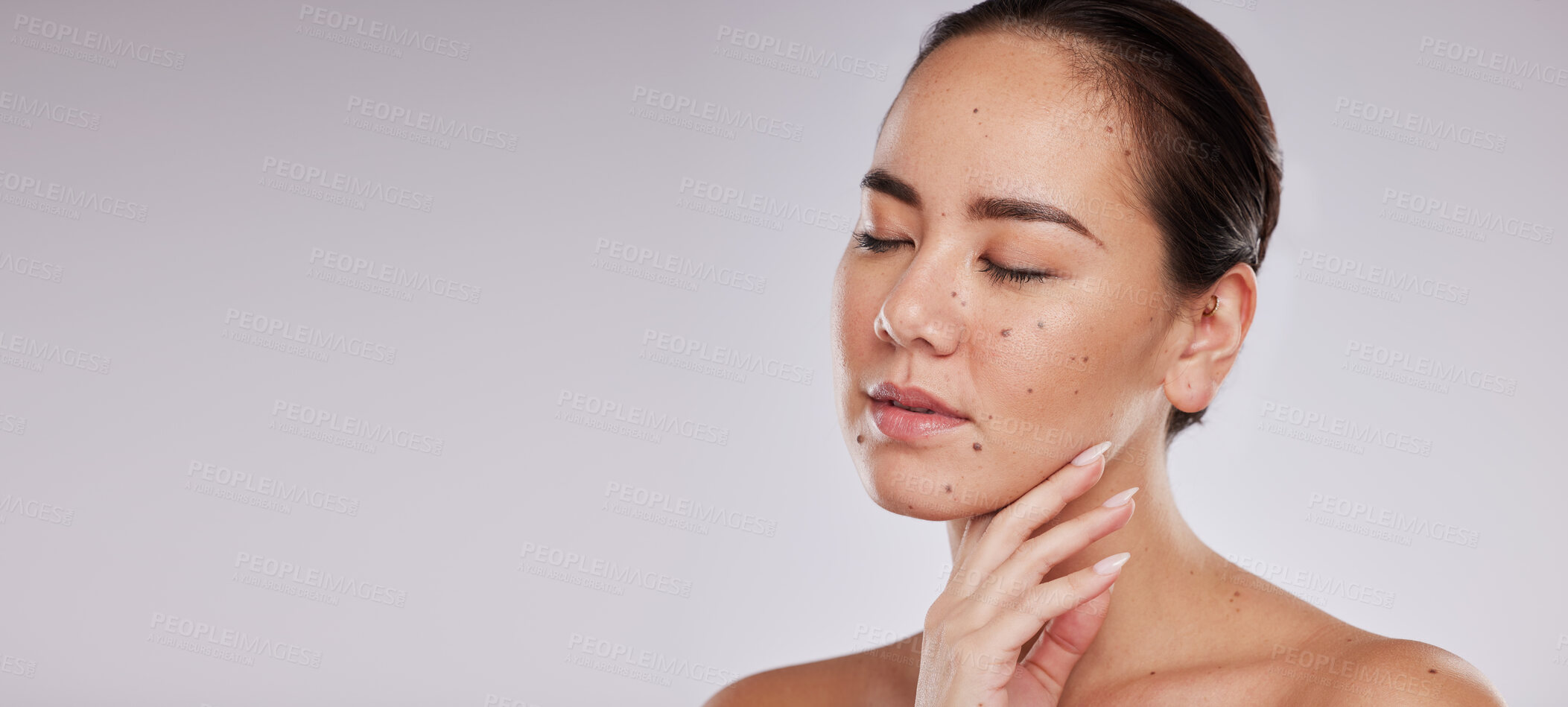 Buy stock photo Beauty, face and woman with skincare mockup in studio for dermatology cosmetics and skin glow. Aesthetic asian model person hand for makeup shine and luxury self care facial on grey background