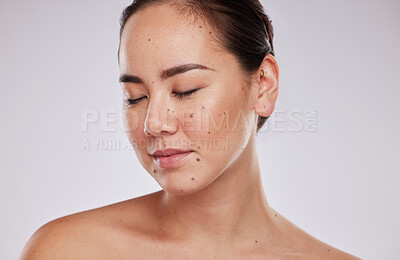 Buy stock photo Skincare, face and beauty of a woman in studio for cosmetic, dermatology and makeup shine. Aesthetic asian model person with wellness glow, mole on skin and luxury facial self care on grey background