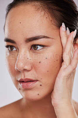 Buy stock photo Beauty, hand on face and woman in studio for skincare, dermatology and cosmetics for skin glow. Aesthetic asian model person with makeup, mole and luxury facial self care for health and wellness