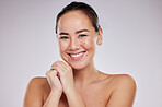 Face portrait, skincare and smile of woman in studio isolated on a gray background. Makeup, beauty cosmetics and happy female model with glowing, healthy or flawless skin after spa facial treatment.