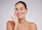 Face portrait, smile and skincare of Asian woman in studio isolated on a gray background. Makeup, beauty cosmetics and happy female model with glowing, healthy or flawless skin after facial treatment