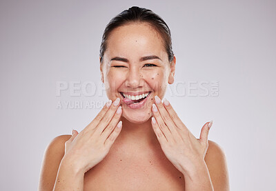 Buy stock photo Portrait, funny and Asian woman with skincare, cosmetics and happiness against grey studio background. Face, female and lady with makeup, Japan and organic facial with treatment, expression and shine