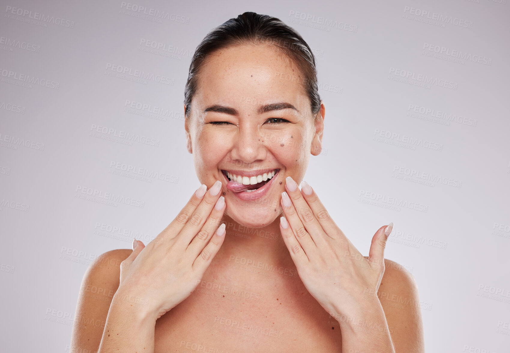 Buy stock photo Portrait, funny and Asian woman with skincare, cosmetics and happiness against grey studio background. Face, female and lady with makeup, Japan and organic facial with treatment, expression and shine