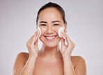 Face portrait, skincare cotton and Asian woman in studio isolated on a gray background. Makeup hygiene, beauty dermatology and happy female model with facial pad or product for cleaning cosmetics.