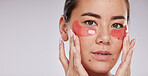 Skincare, face portrait and woman with eye patches in studio isolated on a gray background mock up. Dermatology, cosmetics and female model with facial pads or products for beauty or skin treatment.