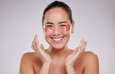 Buy stock photo Asian woman, portrait smile and eye patches for skincare cosmetics, collagen or facial against a gray studio background. Happy female smiling in beauty with face mask or patch under eyes for wellness