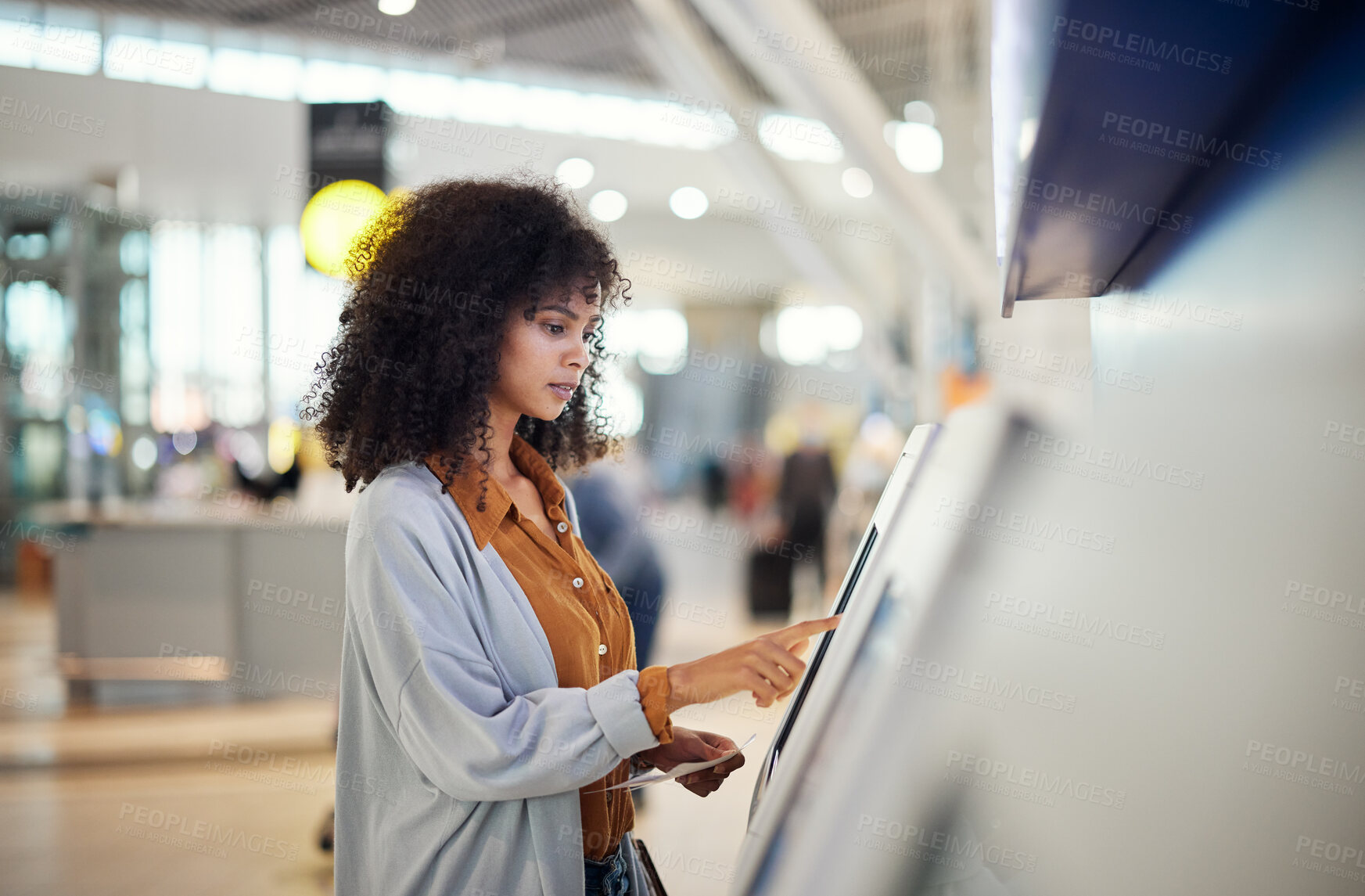 Buy stock photo Black woman, airport and self service station for ticket, registration or online boarding pass. African American female traveler by terminal machine for travel application, document or booking flight