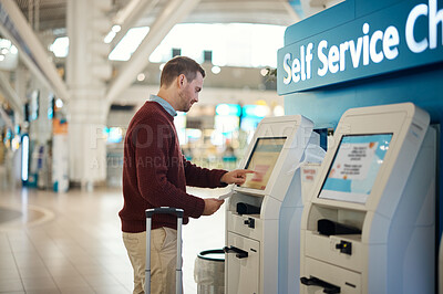 Buy stock photo Man, airport and self service kiosk for check in, ticket registration or online boarding pass. Male traveler by terminal machine for travel application, document or booking flight with luggage