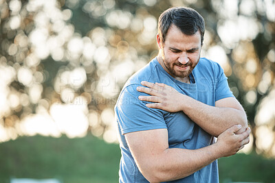 Buy stock photo Fitness, injury and man with shoulder pain in park for running, exercise or training accident of muscle. Sport, guy and injured arm by runner in nature for cardio workout while suffering arthritis